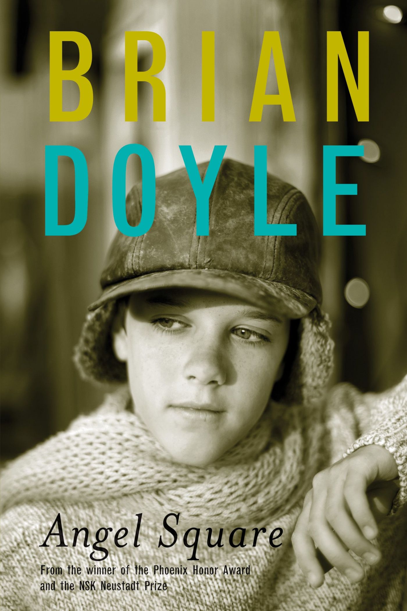 Colour photograph of a young boy wearing a wool cap and sweater, looking thoughtful. Text typewritten in English. The author’s name appears in yellow and blue.
